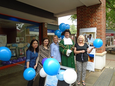 group with baloons outside Community Free Space