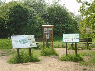 NE corner of site showing benches, Plackaards and notice board.