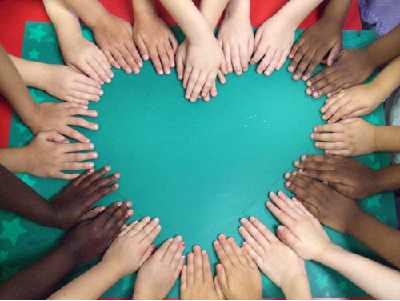 Many hands forming a heart shape