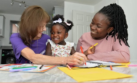 Home Start volunteer with children