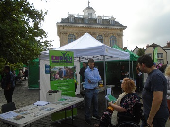 Enrych stallholder talking to people