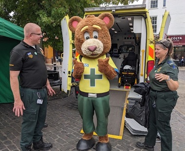 Bear mascot with two of the ambulence team